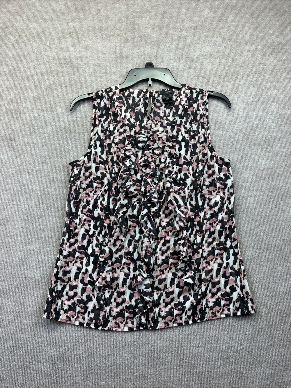 Ann Taylor sleeveless blouse features a bold black and pink abstract animal prin